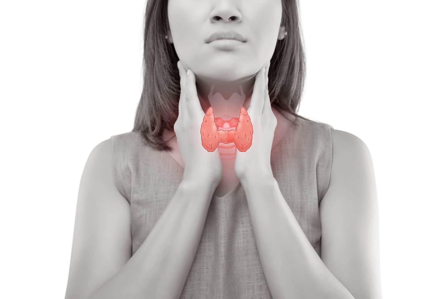 Woman holding her throat with a diagram of a thyroid.